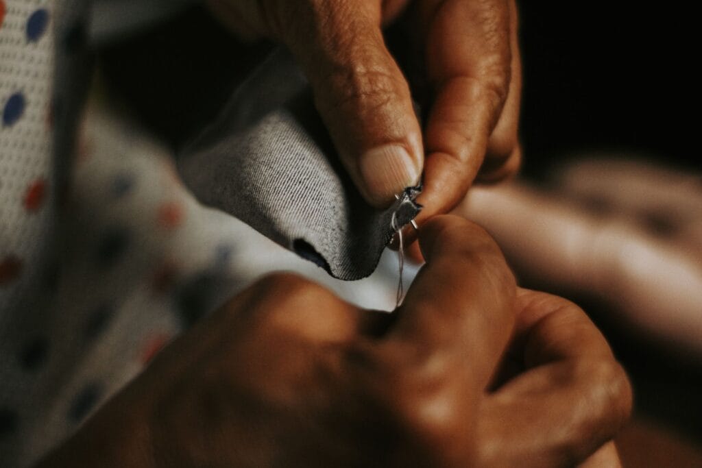 Artisan hand-stitching a luxury garment