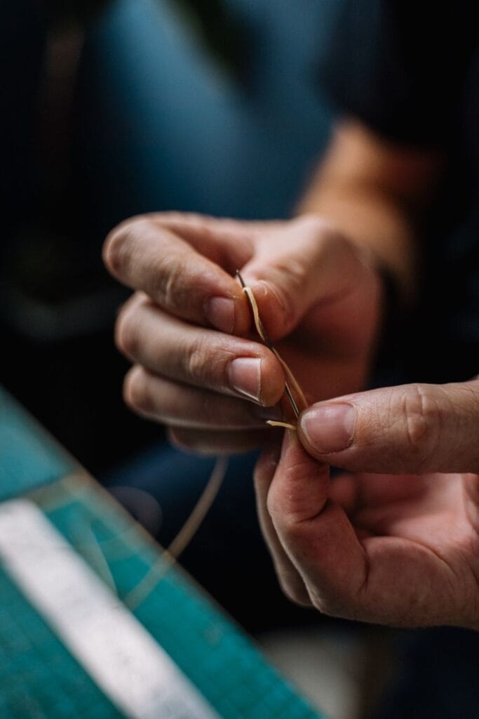 Hand sewing a sleeve on a luxury garment