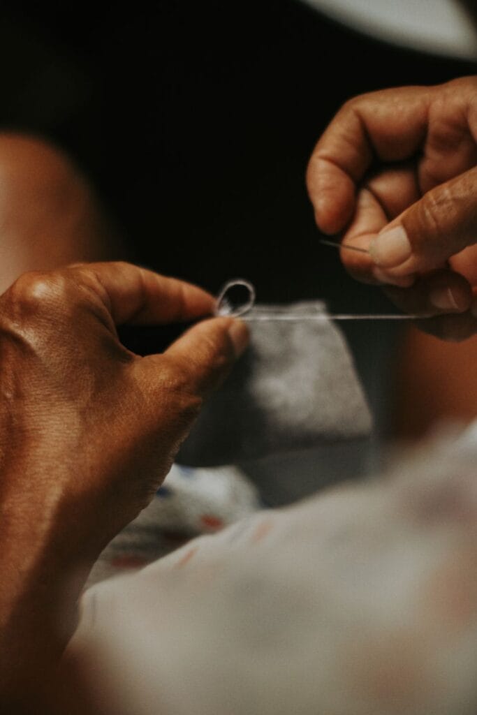Hand sewing a soft garment in a dressmaking atelier
