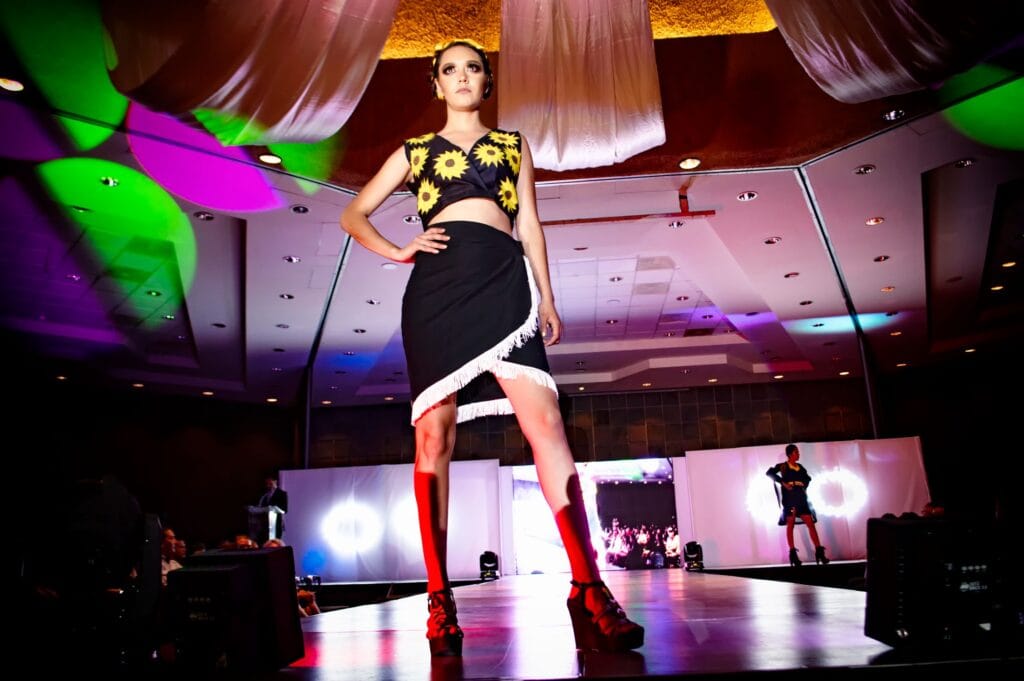 Model wearing a printed garment on the runway