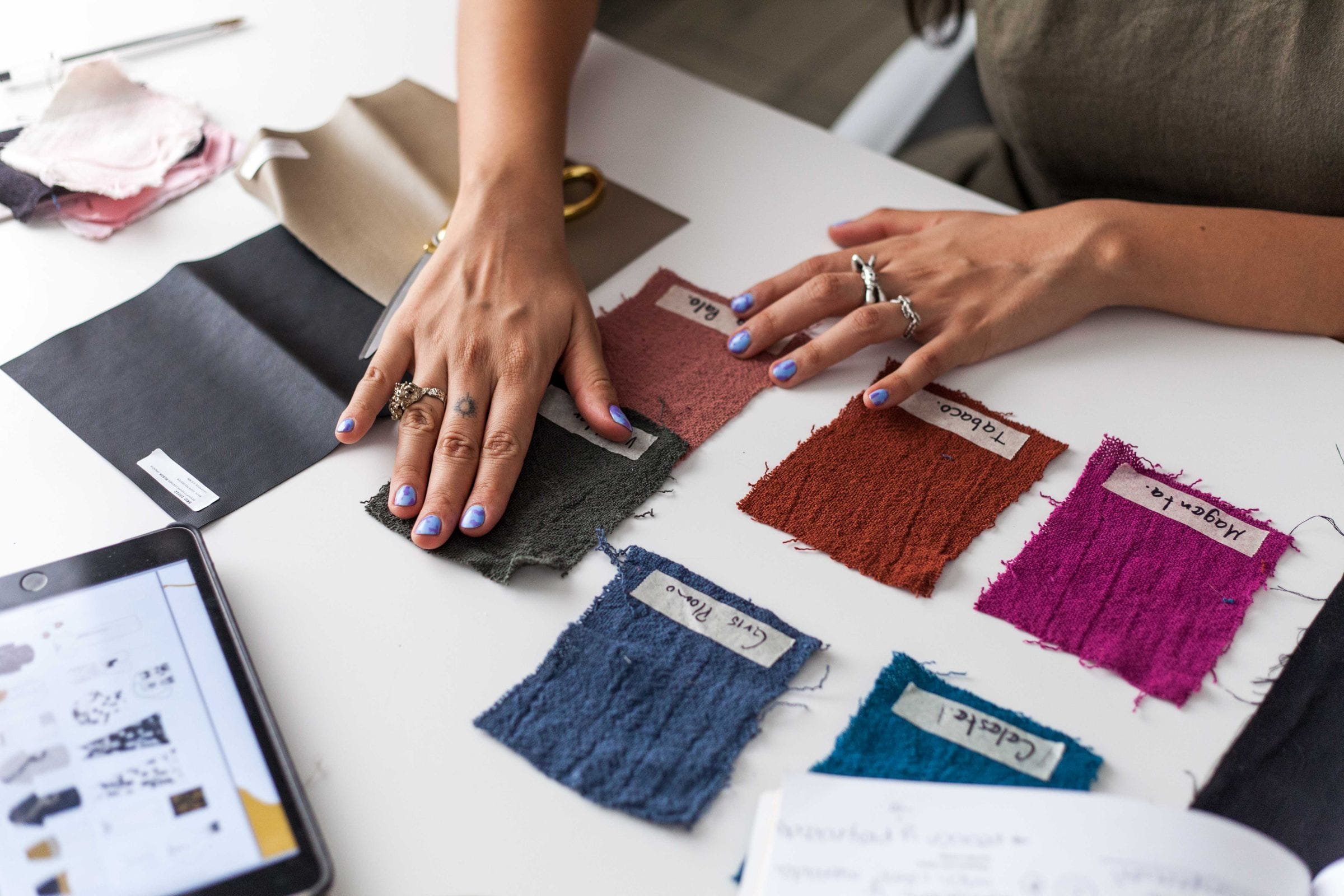 Selecting luxury fabric swatches in an atelier