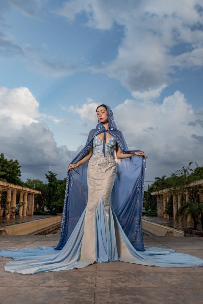 Model in a structured caped gown