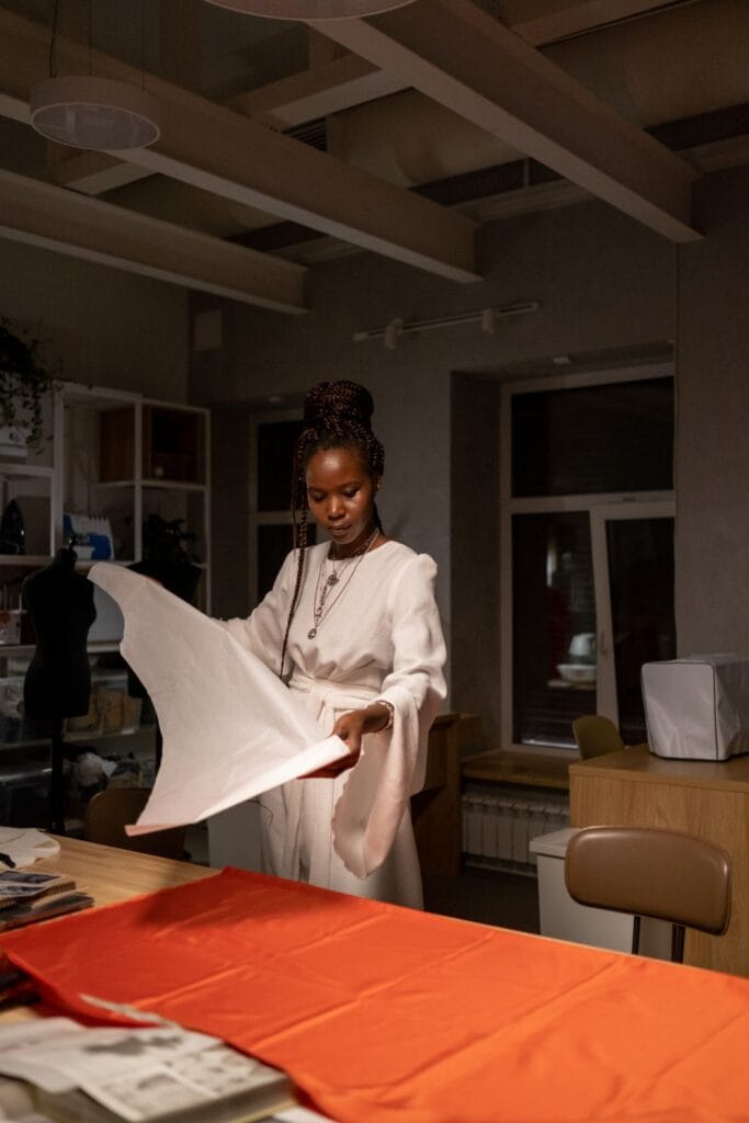 Tailoring workspace with garments and trouser making in progress