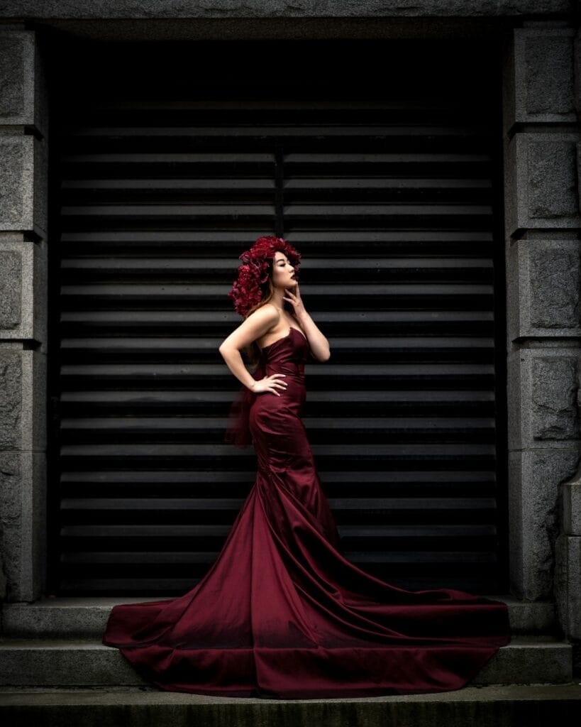 Model in a dramatic burgundy evening gown
