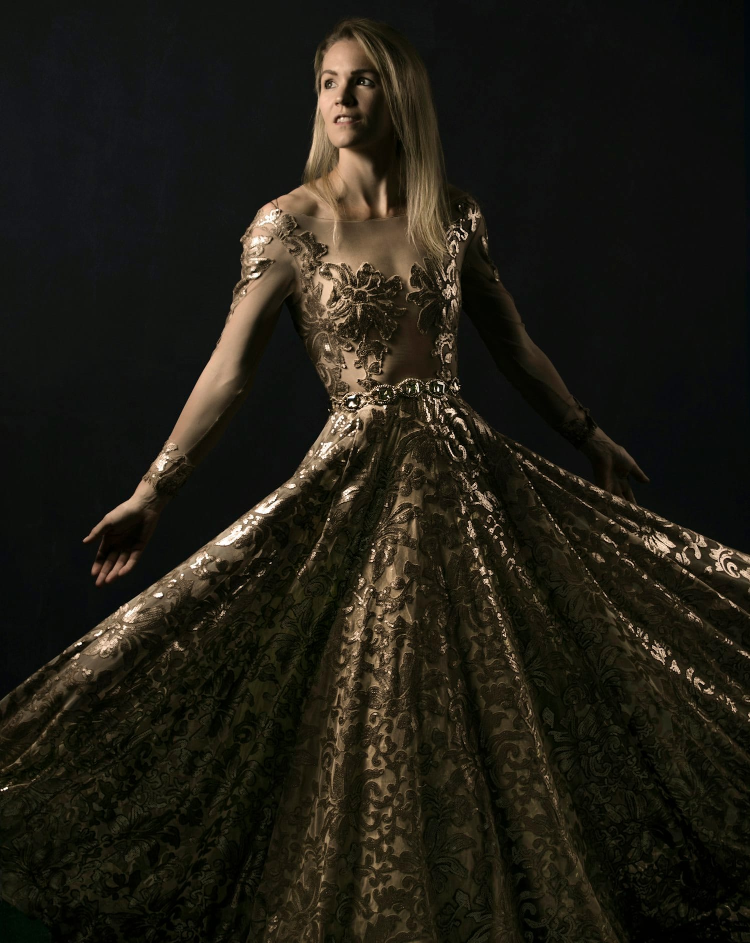 Model in a black and gold evening gown
