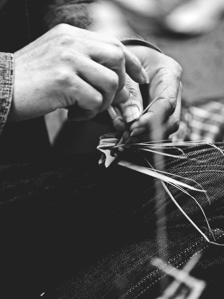 Hands cutting fabric with scissors