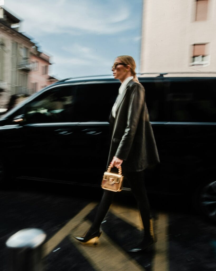 Model walking a Milan street with a designer bag