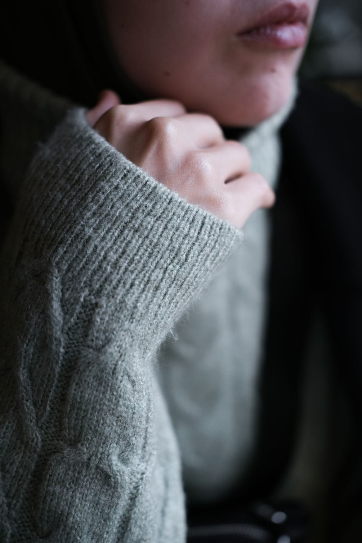 Model in a grey knitted sweater