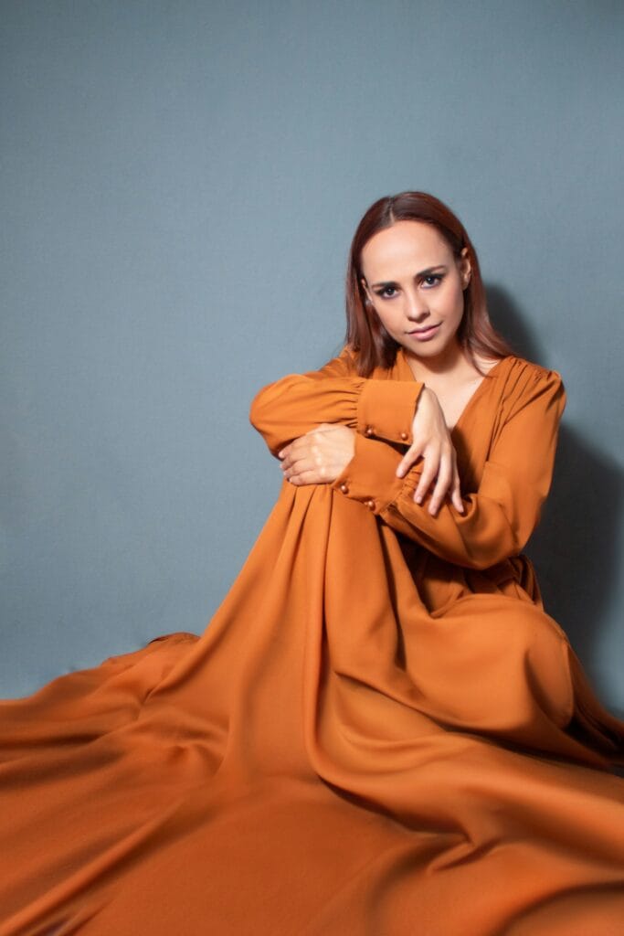 Editorial model in an orange dress