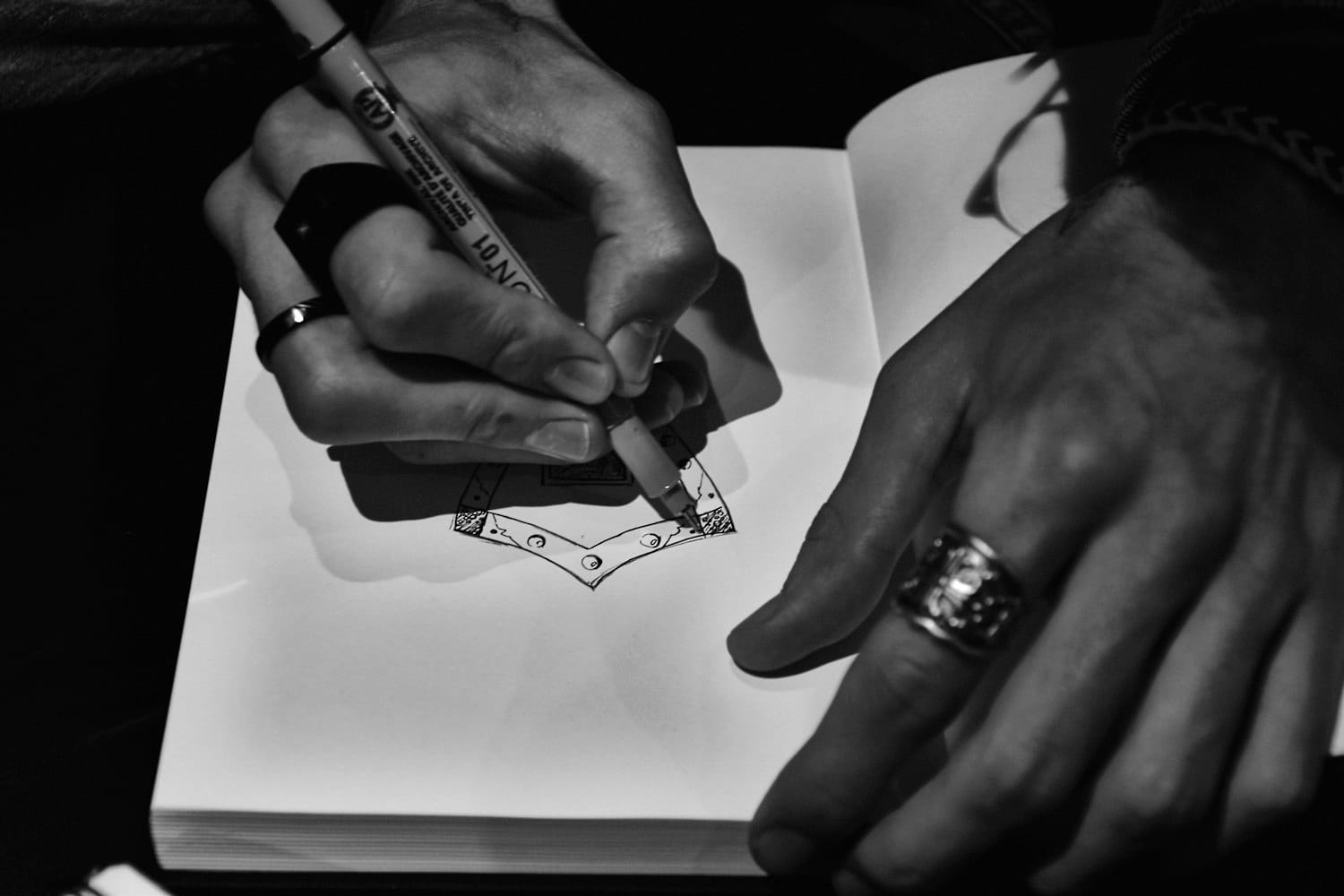 Hands sketching a garment design