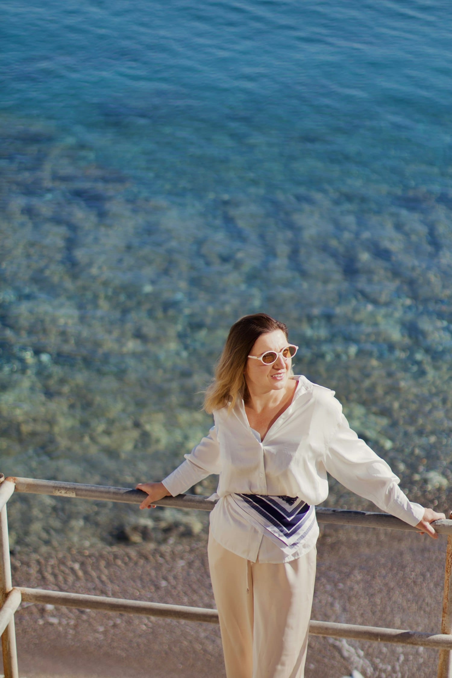 Model in resortwear by the sea