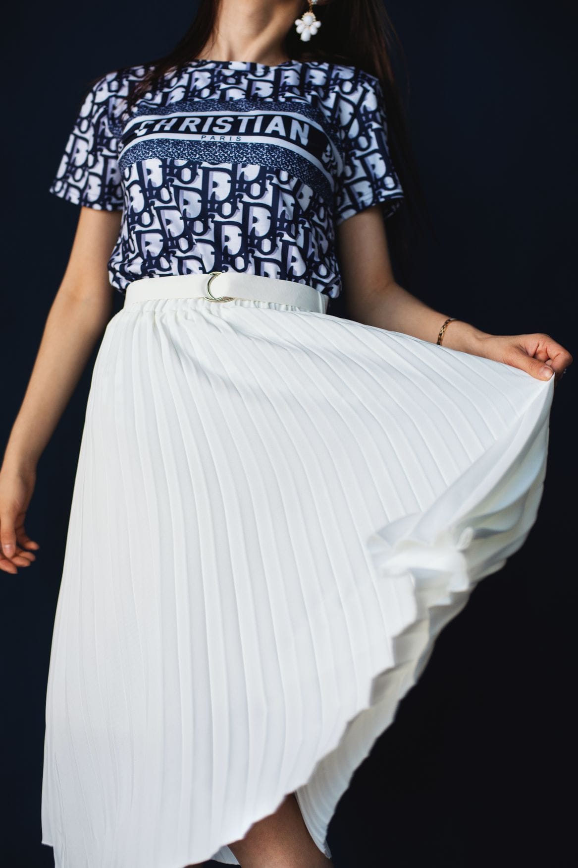 Model in a pleated midi skirt