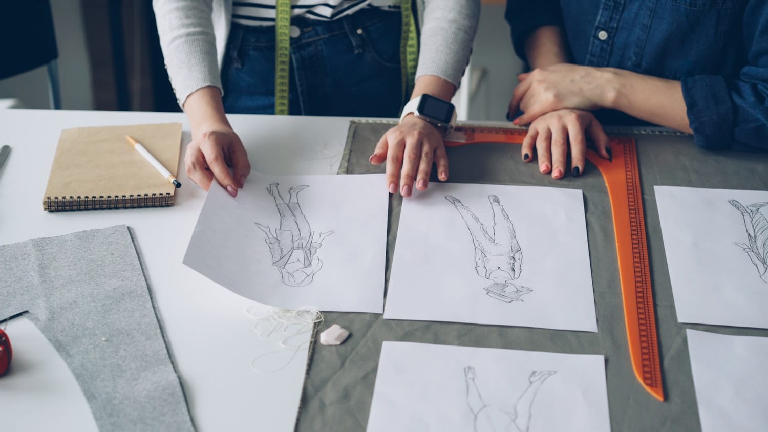 Designers reviewing sketches and fabrics