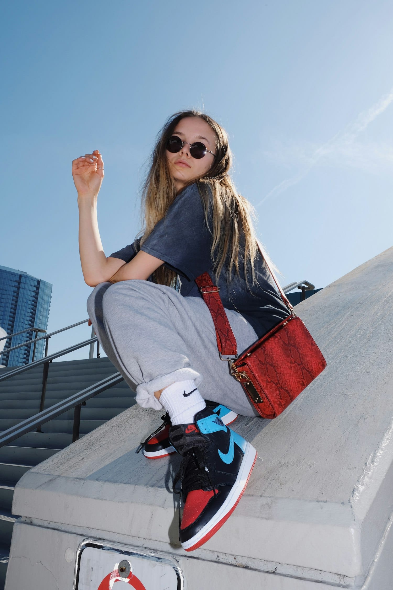 Model in casual streetwear on a bench