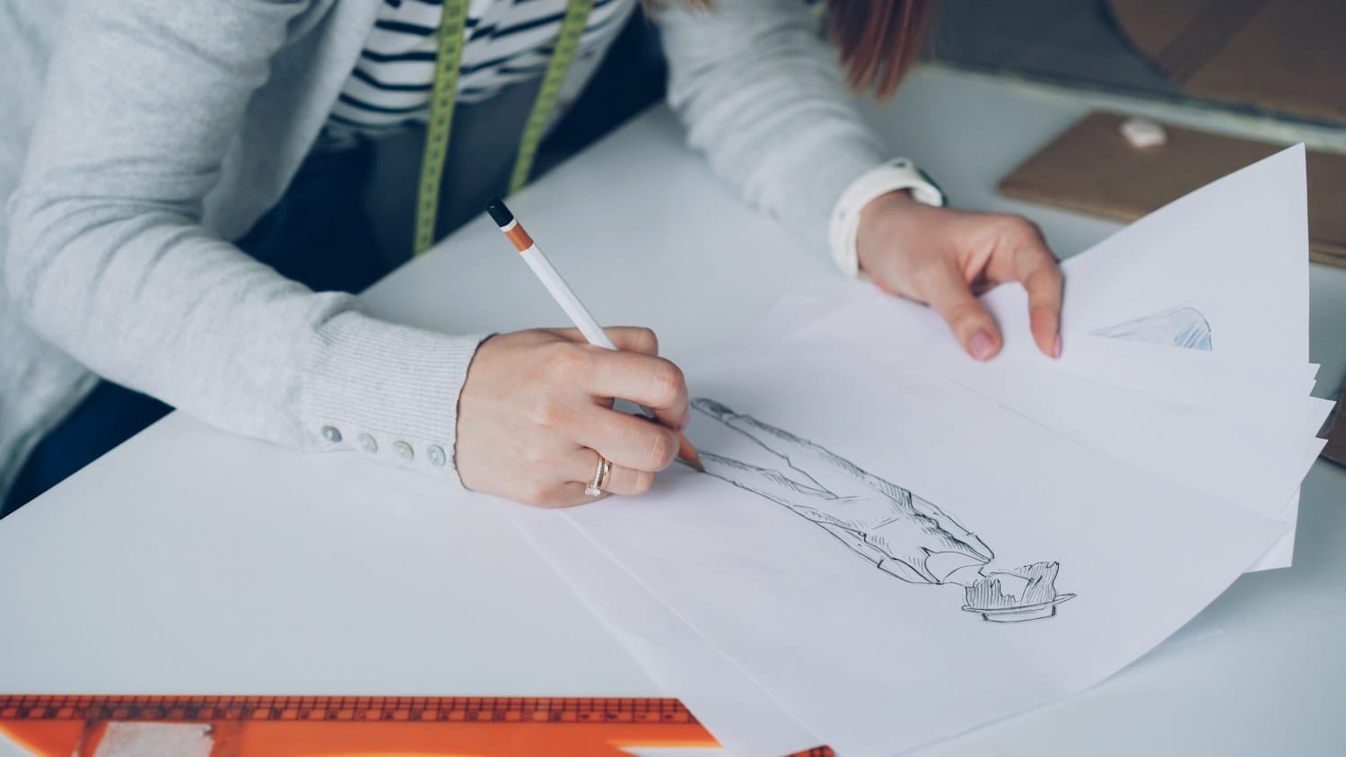 A designer sketching a garment