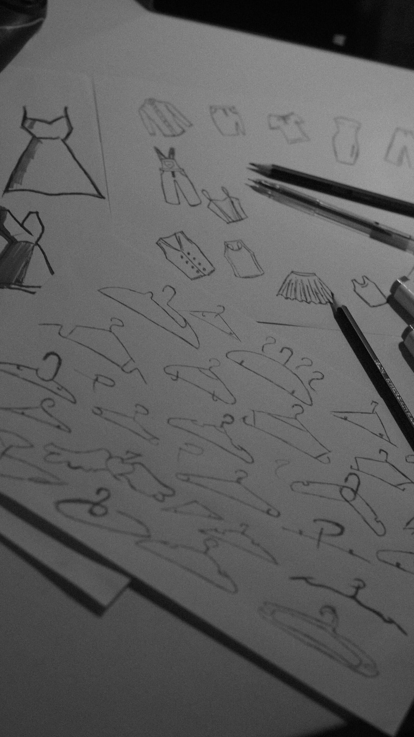 Clothing design sketches on paper