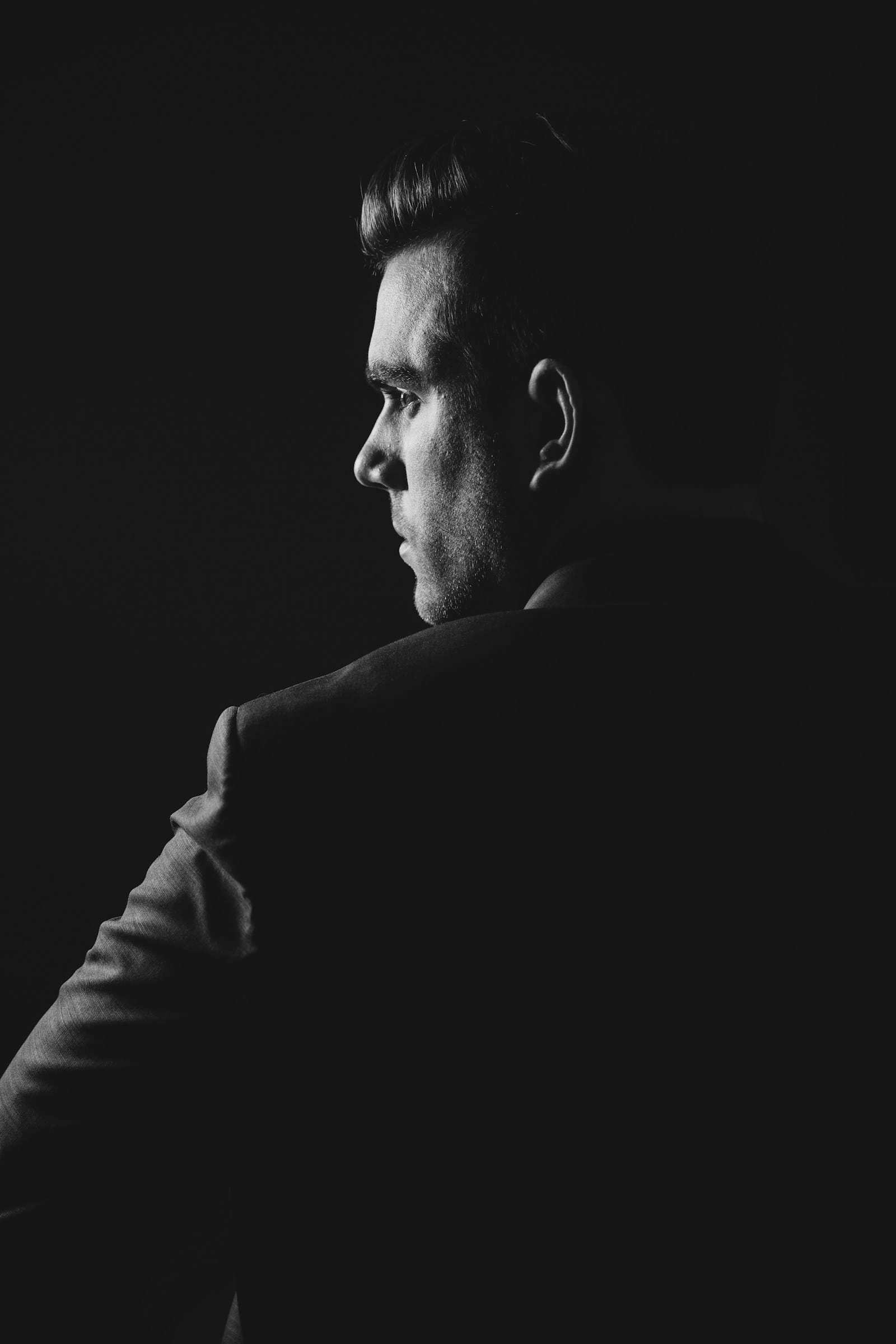 Shoulder line of a tailored jacket in low light, menswear production