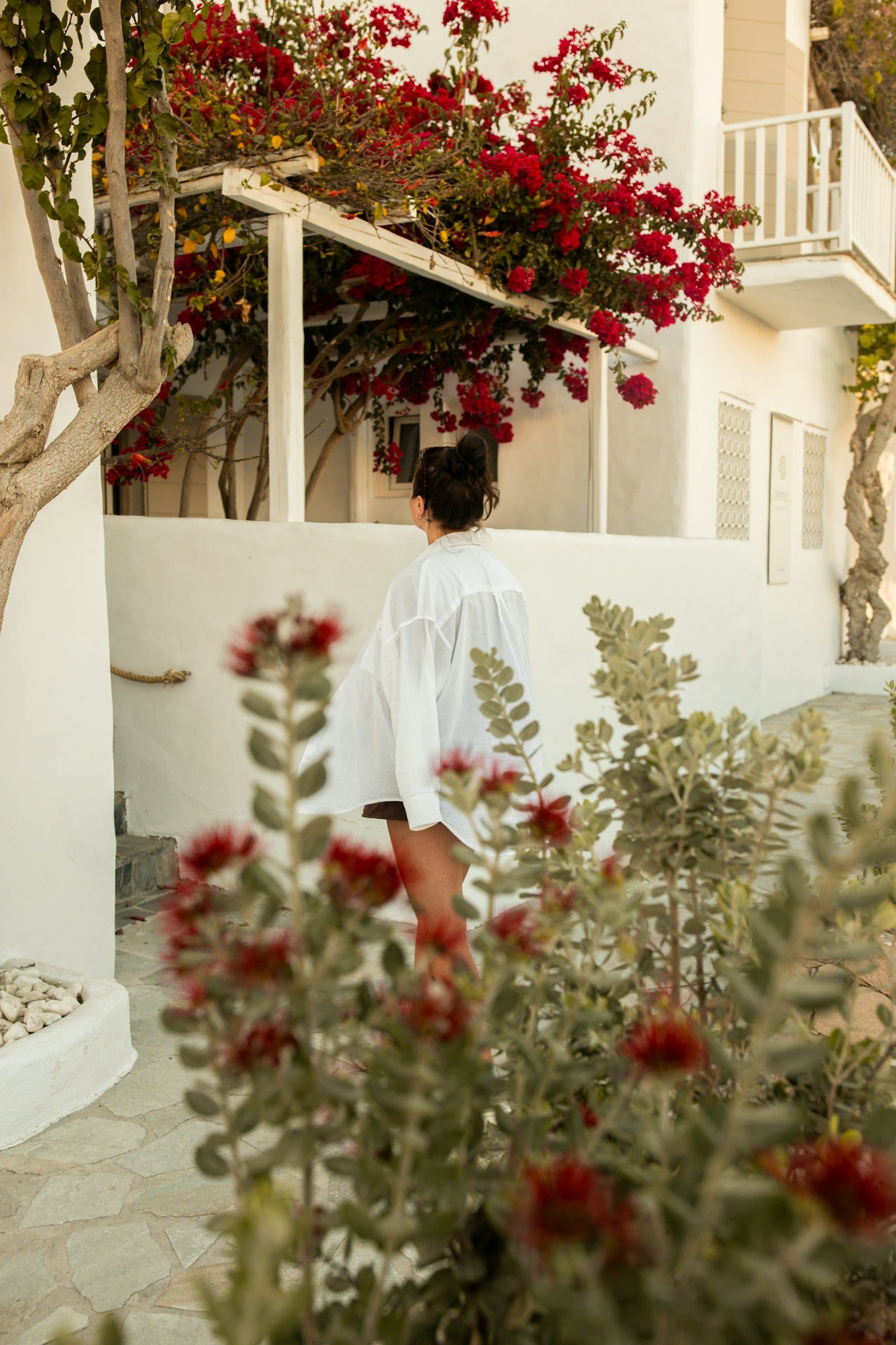 Oversized linen shirt worn in a Mediterranean resort setting
