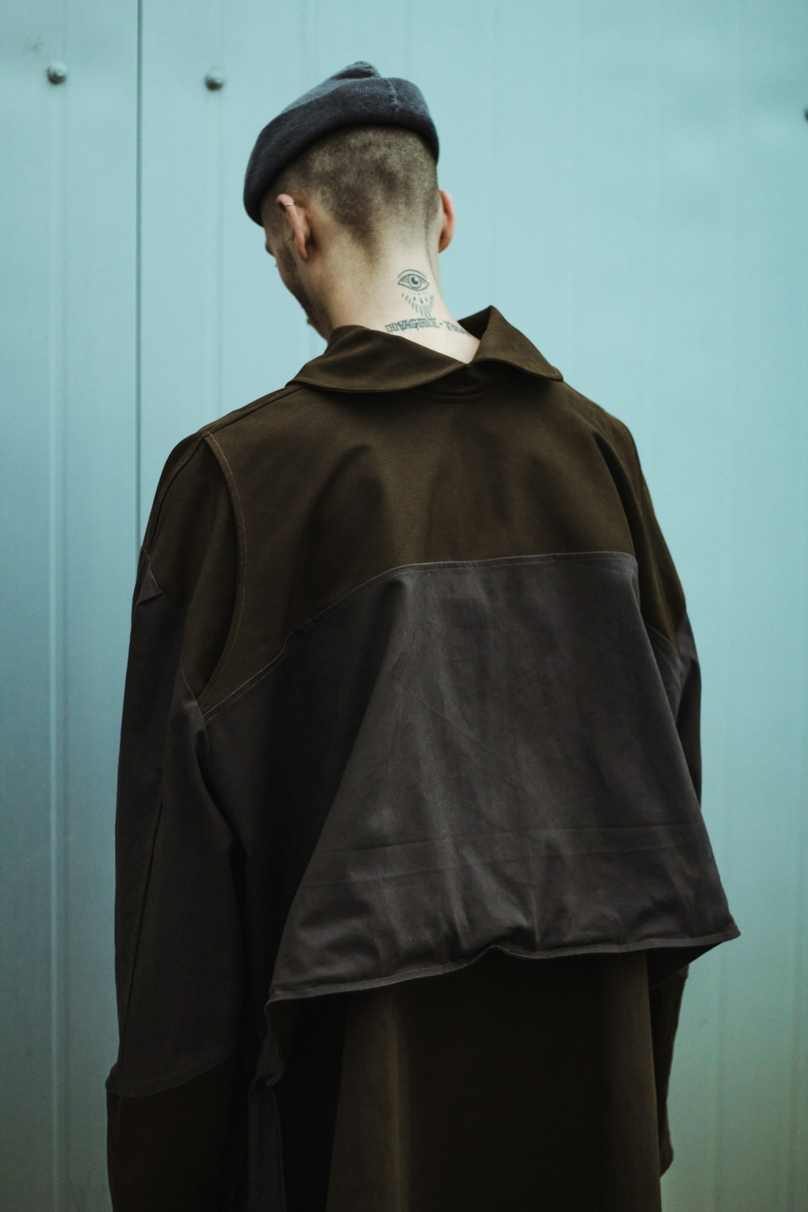 Oversized panelled streetwear piece seen from the back, showing seam construction